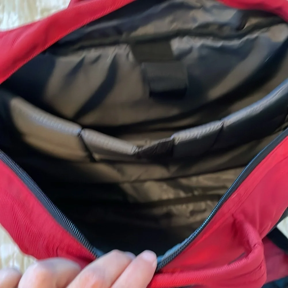Red Jansport laptop messenger bag. Interior Velcro & outer zippered compartment